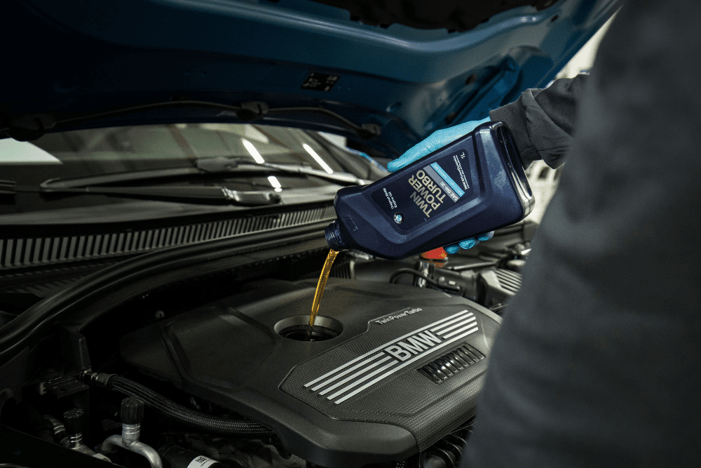 bmw oil leaks, auto repair in Bend, OR at Mountain View Imports. Engine oil being poured into a BMW engine during a professional oil change.