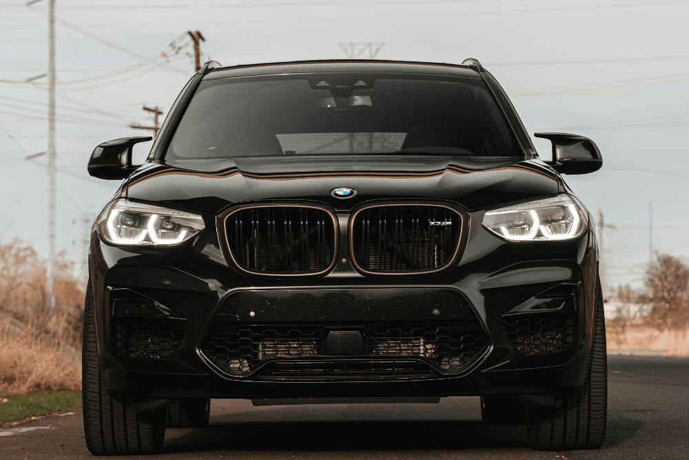 spring maintenance, auto repair in Bend, OR at Mountain View Imports. Front view of a black BMW SUV parked on a road, showcasing its aggressive grille, modern headlights, and bold design—ideal image for European vehicle service promotions.